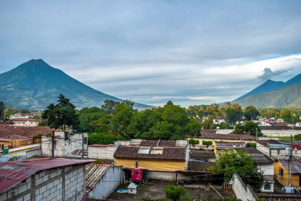 A panoramic view of Antigua with the erupting Volcano El Fuego and Volcano Agua in Guatemala