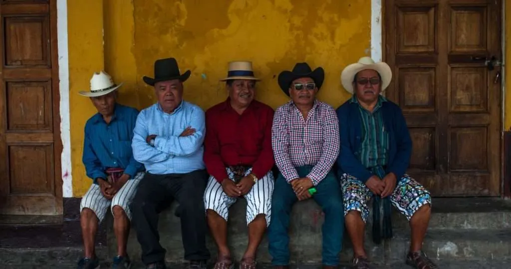 Group of men is having their Sunday chat at the church's yard in Santiago, Lake Atitlan, Guatemala