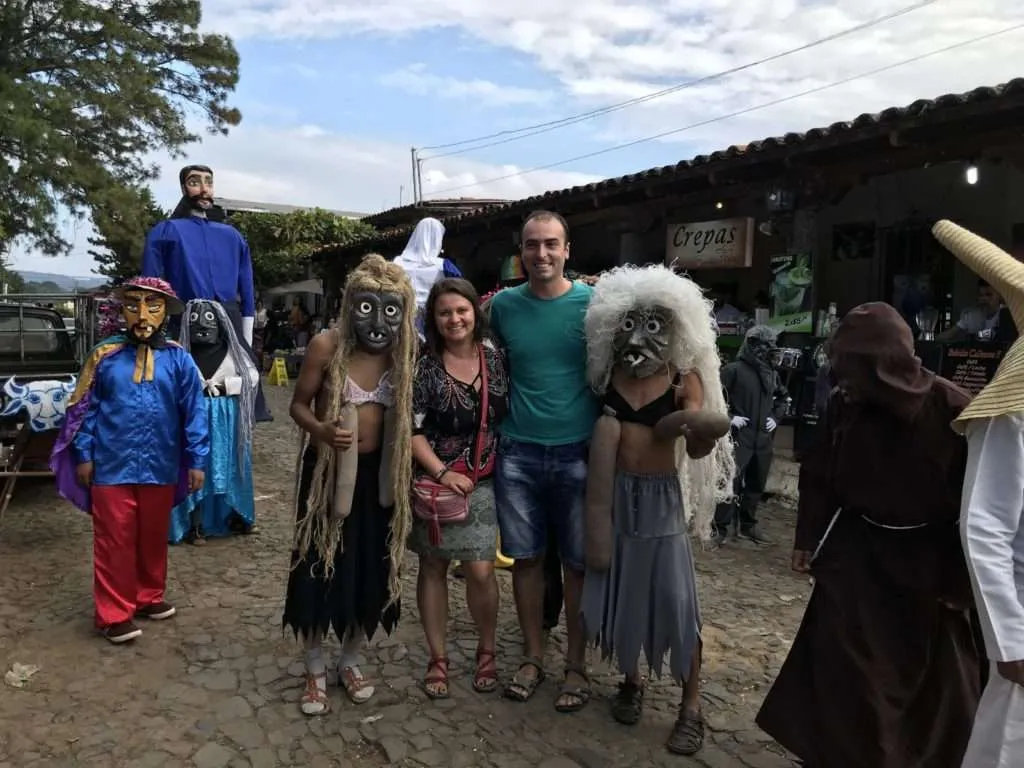 People in masks are dancing for their Sunday festival in Ataco, Ruta de las Flores, El Salvador
