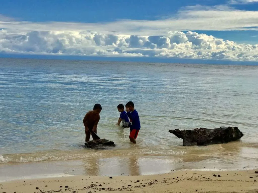 Children playing on the beach in Utila island, Honduras