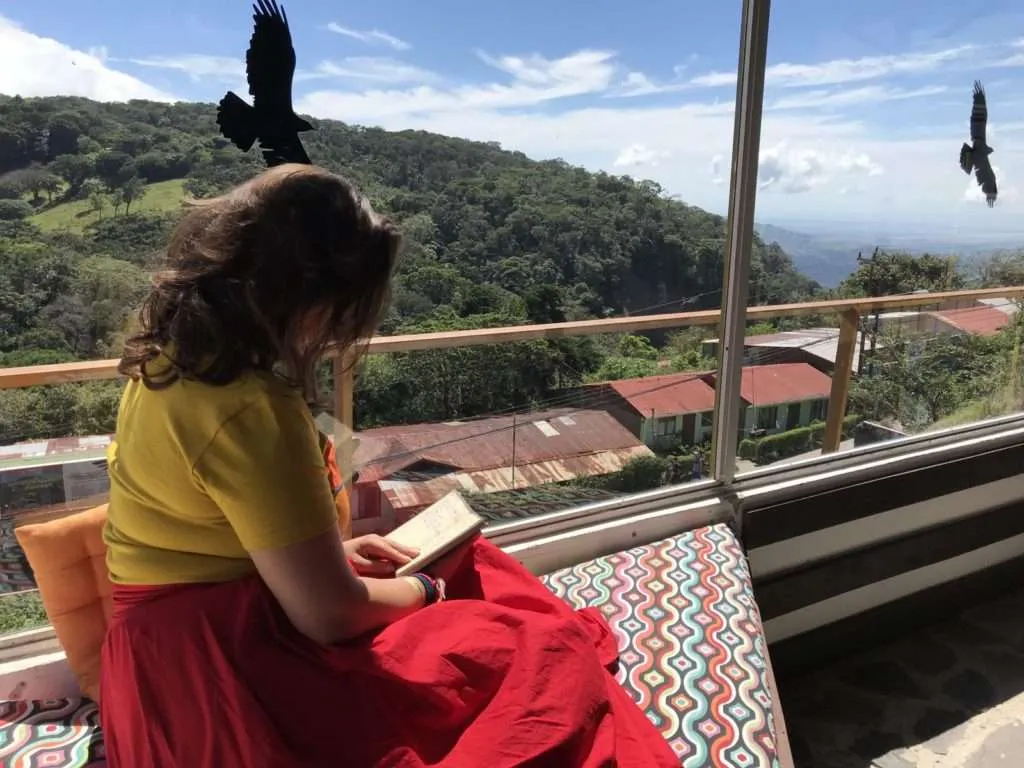Bistra is reading and the Monteverde national park scenery smiles next to her, Costa Rica
