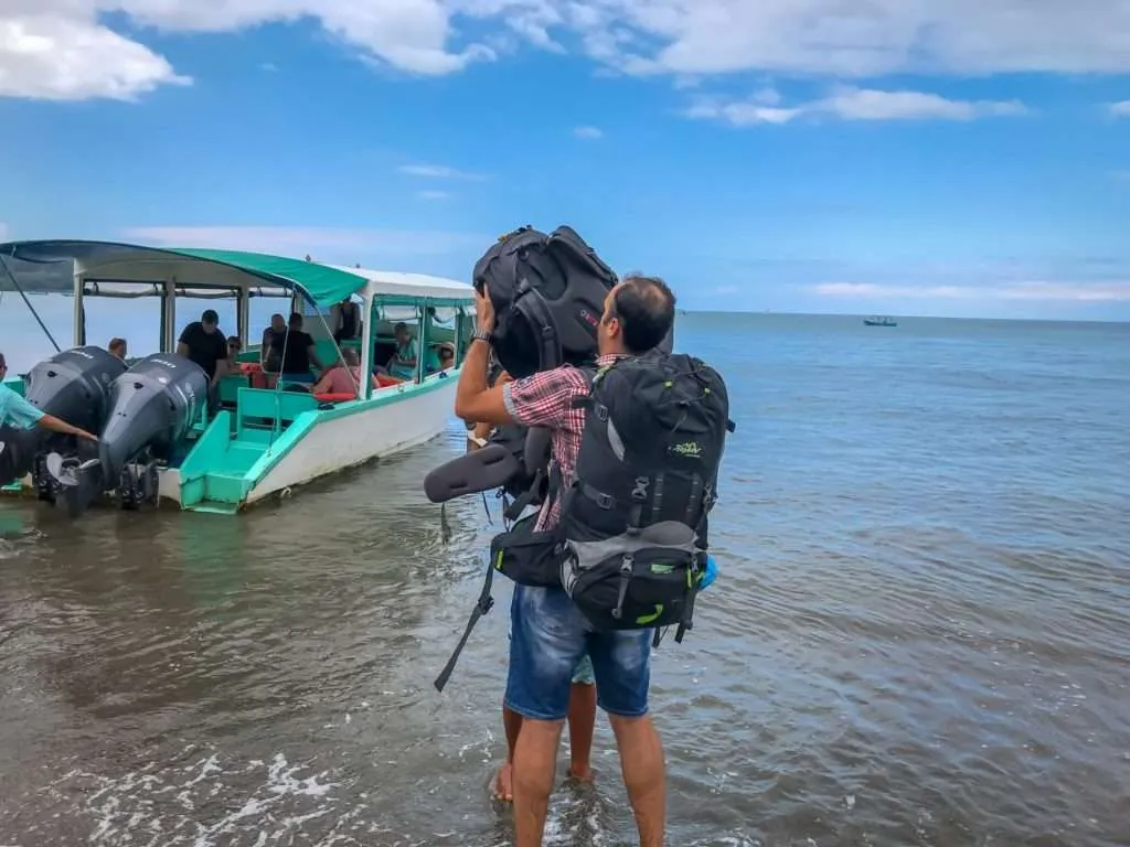 Nace is getting the backpacks from the boat in Drake Bay, Corcovado National Park, Costa Rica