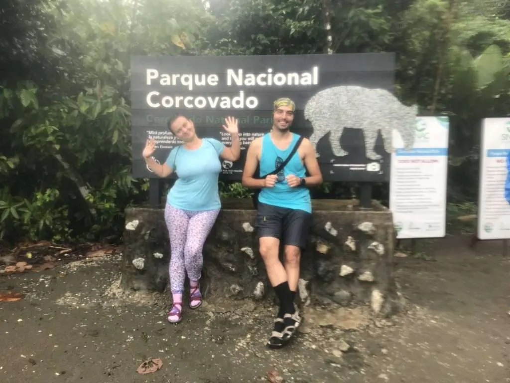 We are wet and with happy smiles on our faces at the entrance of the Corcovado National Park in Costa Rica