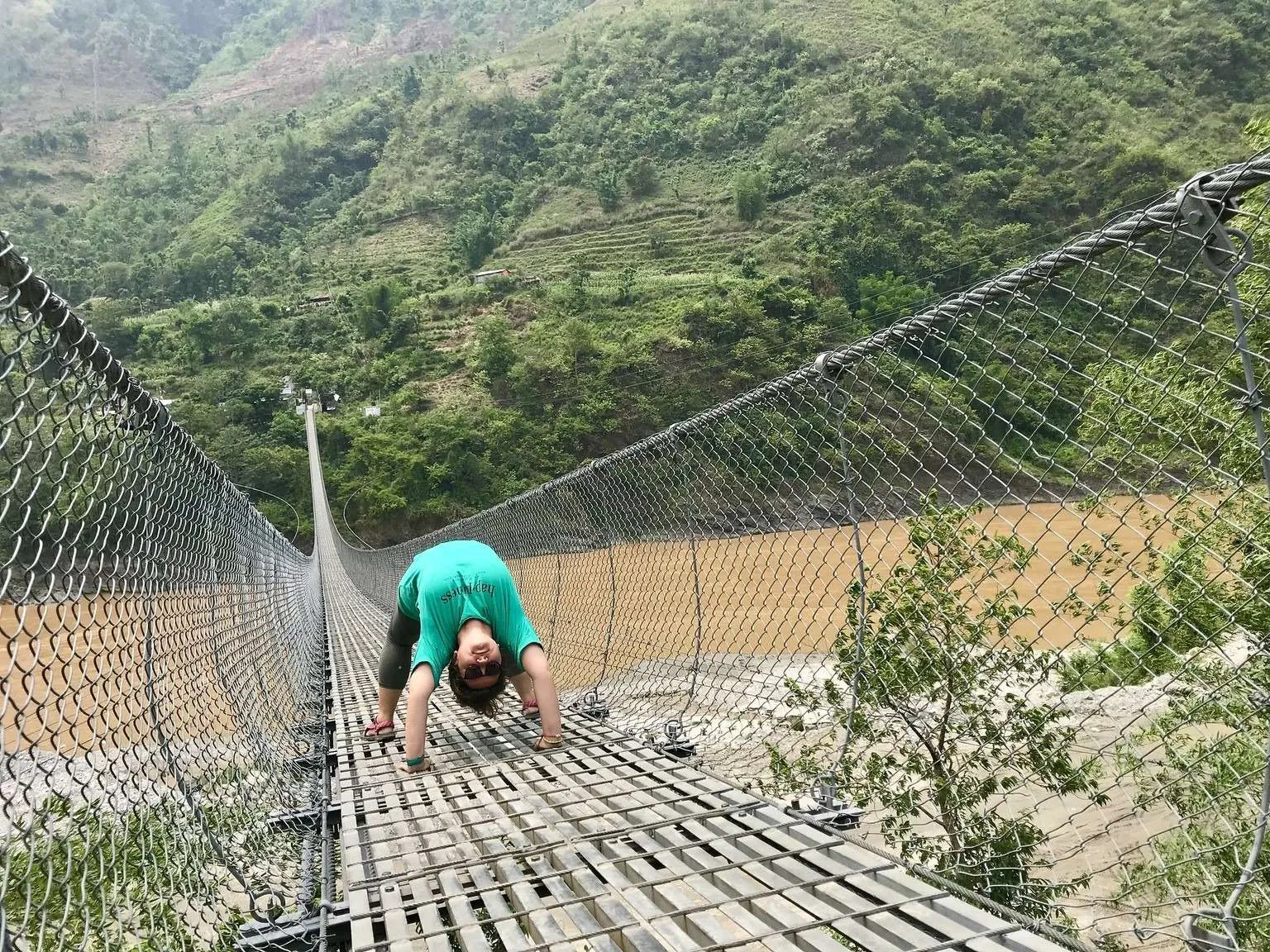 Nepal itinerary, meeting Nepali people - chakrasana on a suspension bridge