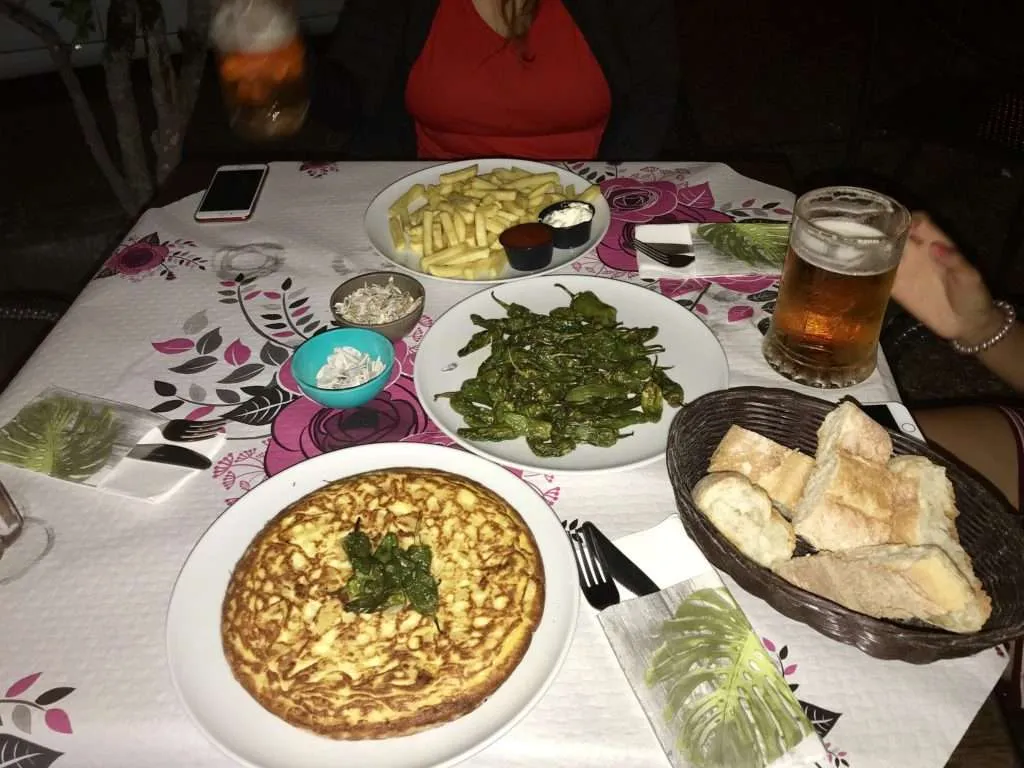 Spain, Camino de Santiago food - tortilla, pimientos del Padron, beer, bread