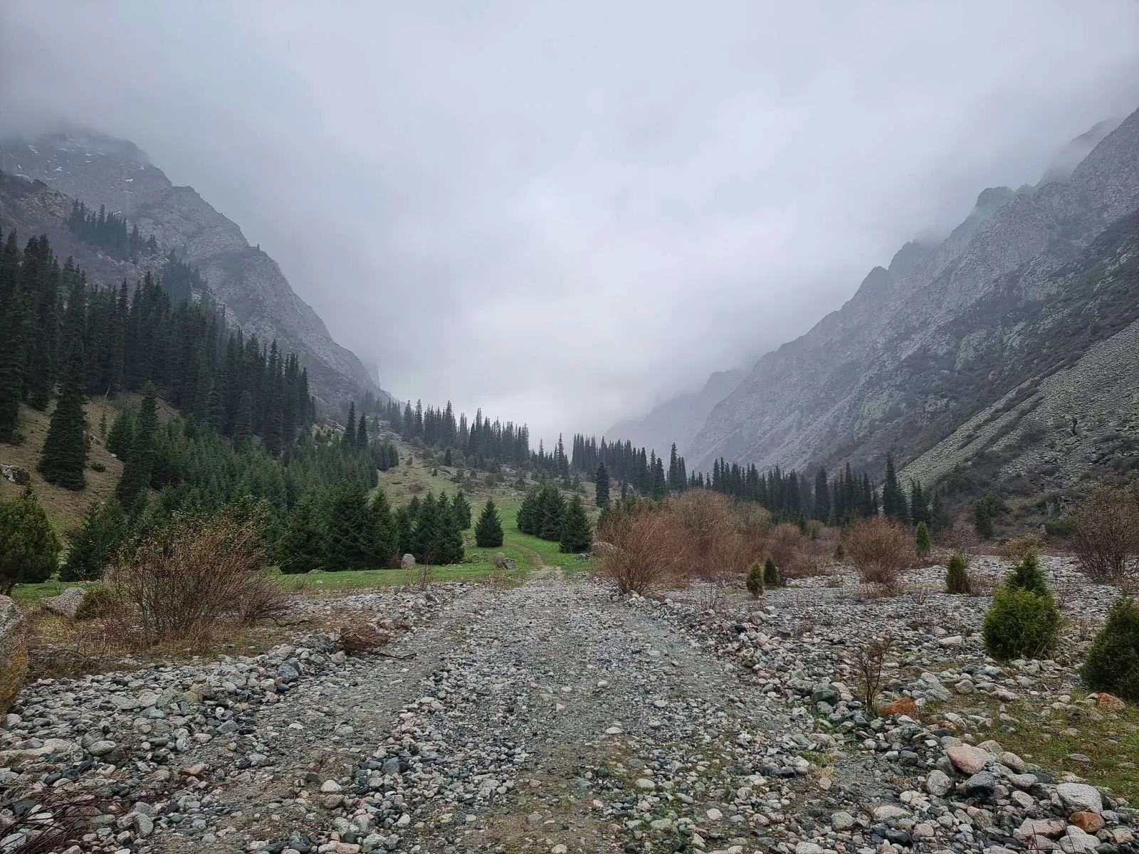 Ala Archa National Park Kyrgyzstan - Rocky road to the green and foggy forest