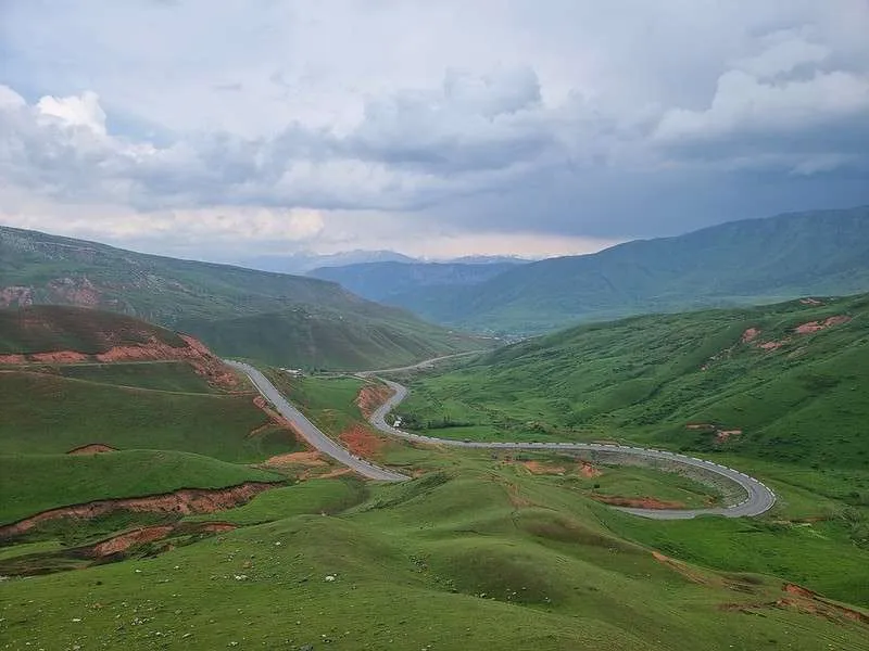day 7 Pamir Highway Kyrgyzstan from Lake Tulpar-Kol to Osh green landscape with snake shaped road